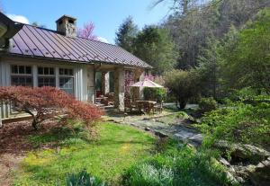a house with a table and chairs in a yard at Entire Estate-High Country-Valle Crucis-Sleeps 12 in Valle Crucis