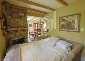 a bedroom with a bed and a stone fireplace at Entire Estate-High Country-Valle Crucis-Sleeps 12 in Valle Crucis