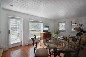 a living room with a glass table and two windows at Entire Estate-High Country-Valle Crucis-Sleeps 12 in Valle Crucis