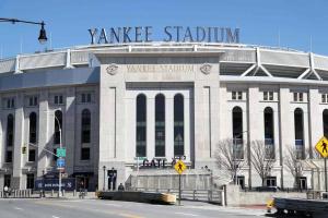 a large white building with a sign on top of it at Cozy Stylish retreat - NYC & NWK w free parking in Bayonne