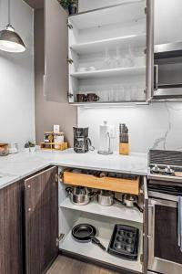 a kitchen with a stove and some pots and pans at Cozy Stylish retreat - NYC & NWK w free parking in Bayonne