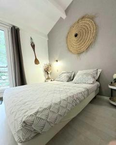 um quarto com uma cama grande e uma cesta na parede em La Villa du Menhir Gîte em Bize-Minervois