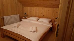 a bedroom with a bed with towels on it at Holiday House Bella in Bihać