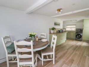 a kitchen and dining room with a table and chairs at 2 Penporth in Rhayader