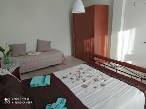 a bedroom with two beds and a bed with towels at Chora Country House in Kalymnos