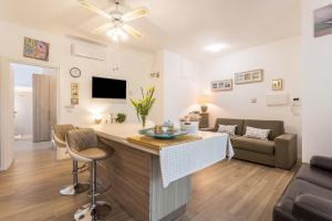 una cucina e un soggiorno con divano e tavolo di Casa Di Lux E Max - Sub 701 a Brugherio