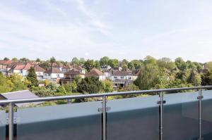 a balcony with a view of houses at Palm Tree House - Candyland in Orpington