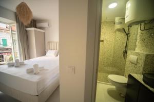a bedroom with a bed and a bathroom with a toilet at Marco Polo in Petrovac na Moru +28 photos