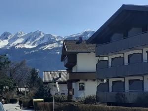 a apartment building with mountains in the background at Alpha Alpin Apartment in Zell am See