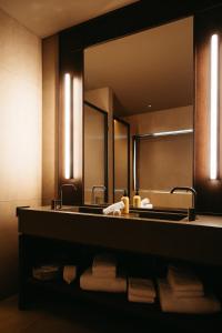 a bathroom with a sink and a mirror at Signature by Vík Apartments in Vík