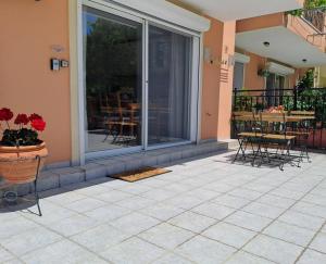 a patio with chairs and a table on a balcony at Corfu Lakeside Cottage in Kanoni