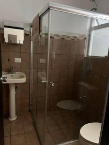 a bathroom with a shower and a toilet and a sink at Casa Matiza in Santiago Este