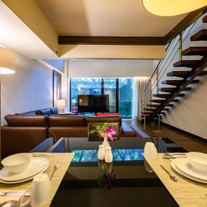 a living room with a couch and a table at Las Suites Campos Eliseos in Mexico City