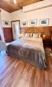 a bedroom with a large bed and a wooden floor at Villa Andreina Como Lake in Moltrasio