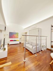 a living room with a white couch and a bed at Like at Home Trastevere in Rome