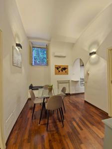a dining room and living room with a table and chairs at Like at Home Trastevere in Rome