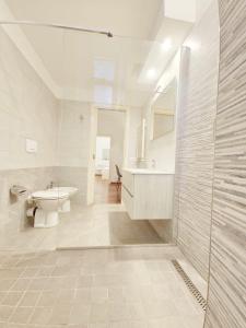 a white bathroom with a sink and a toilet at Like at Home Trastevere in Rome