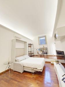 a bedroom with a large white bed and a table at Like at Home Trastevere in Rome +16 photos