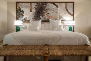a bedroom with a large white bed with two lamps at Hotel Ritual de Terra & SPA Moraira in Moraira +54 photos