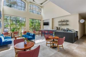 a large living room with tables and chairs at Fiesta Inn Colima in Colima