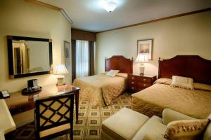 a hotel room with two beds and a mirror at EMBASSY HOTEL in San Francisco