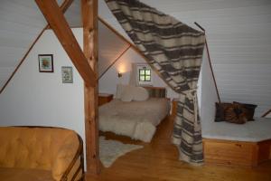 a bedroom with a bed in a attic at Gyöngy Villa in Fonyód