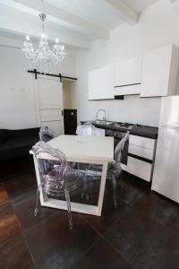 a kitchen with a white table and two chairs at Villa Angel Lampedusa. in Lampedusa +6 photos