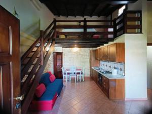 a kitchen with a staircase and a blue couch in a room at VILLA ANNA in Casale la Cogna