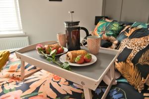 a tray with two plates of food on a coffee table at Quirky & Comfortable Residence in Workington