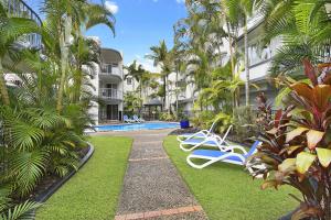 a resort yard with chairs and a swimming pool at Beachside Mooloolaba in Mooloolaba