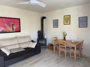 a living room with a couch and a table at La Casa Nueva de la Montaña Santa Lucia de Tirajana in Santa Lucía