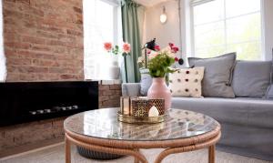 a living room with a glass table with flowers on it at Forest house in Ljungskile