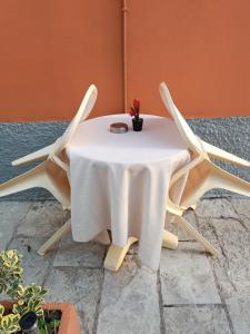 a white table with two chairs around it at Savvas&Katia's luxury studio in Mantoúkion