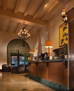 two people sitting at a bar in a restaurant at Kensington Park Hotel in San Francisco