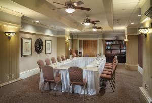 a large meeting room with a large table and chairs at Kensington Park Hotel in San Francisco