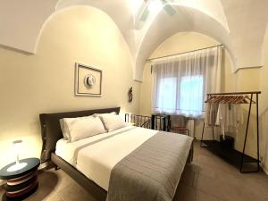a bedroom with a bed and a window at La Chiantata - Abbasciu in San Vito dei Normanni +94 photos