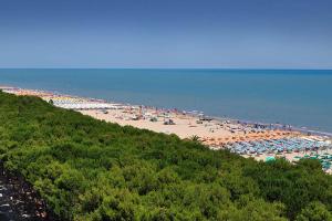a beach with a lot of umbrellas and people at B&B Il Viale in Alba Adriatica