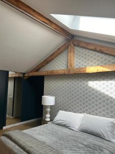 a bedroom with a large bed with a wooden frame at Villa Sardino in Settimo Vittone