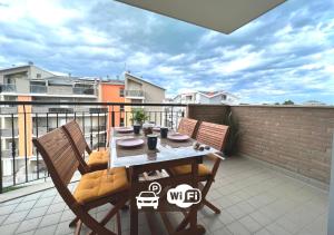 a balcony with a table and chairs on a patio at HoliHome_Parri in Tortoreto Lido