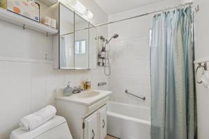 a white bathroom with a sink and a toilet at Palmera Place Uptown Phoenix in Phoenix