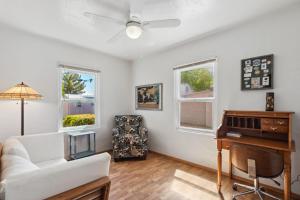 a living room with a white couch and a piano at Palmera Place Uptown Phoenix in Phoenix
