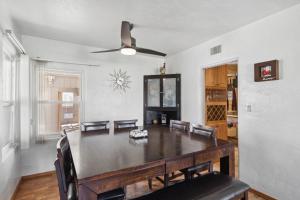a dining room with a table and a ceiling fan at Palmera Place Uptown Phoenix in Phoenix