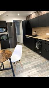 a kitchen with a table and a white chair at Centre Quimper, animaux déclarés acceptés in Quimper