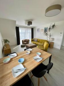 a living room with a wooden table and a couch at Apartmán Bystřice in Bystřice nad Pernštejnem