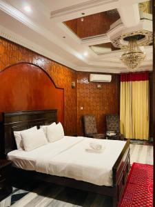 a bedroom with a large bed in a room at Executive Galaxy Guest House in Islamabad