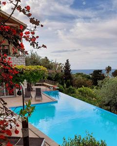 a swimming pool with a view of the ocean at Arenaria L. Villas Complex in Lefkada Town