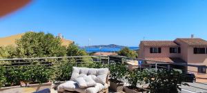 a chair on a balcony with a view of the ocean at Villa Jana in Porto Pollo