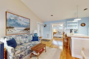 a living room with a couch and a kitchen at Sea Colony - 3701 Tie Breaker in Bethany Beach