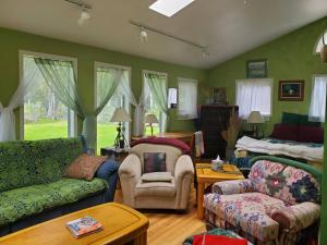 a living room with a couch and a bed at Cottage at Foys Lake Montana in Kalispell
