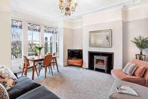 a living room with a table and a fireplace at The Stanley Suite 1 bedroom apt Dog friendly Patio in Harrogate